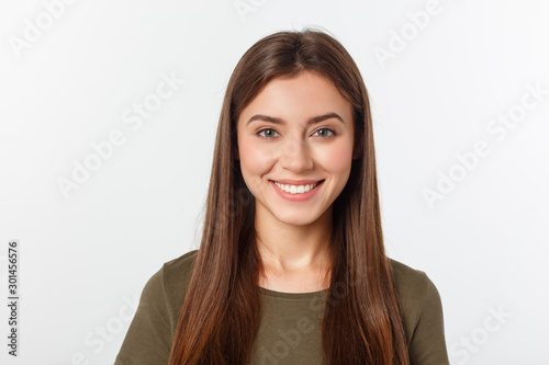 Cuadros en Lienzo Close-up portrait of yong woman casual portrait in positive view, big smile, beautiful model posing in studio over white background