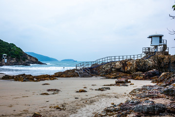 The lifeguards observation tower on the rocks and sand of Big Wave Beach in Hong Kong at sunrise - 2