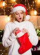 © be free - Be positive. girl in red santa hat. christmas preparation. New year present. winter holidays decorations. Cheerful woman. xmas stocking with presents. happy new year. Gifts from santa claus