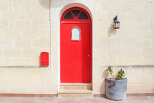Red Medieval Wooden Door Of Old Mediterranean House Facade, Malta