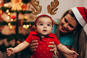 Poster - Mother and her baby playing at home on Christmas holiday