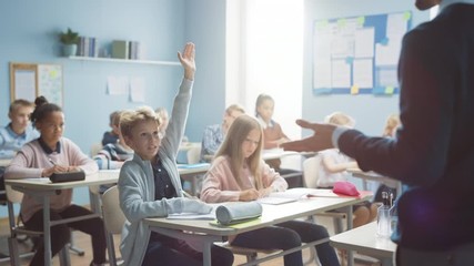 Wall Mural - Elementary Classroom of Diverse Bright Children Listening to the Teacher Giving a Lesson. Boy Raises Hand Knowing the Right Answer. Brilliant Young Kids in School Learning Science, Creative Thinking