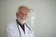 © tharathip - Senior Doctor Photos gray hair expert handsome senior doctor hospital portrait white corridor