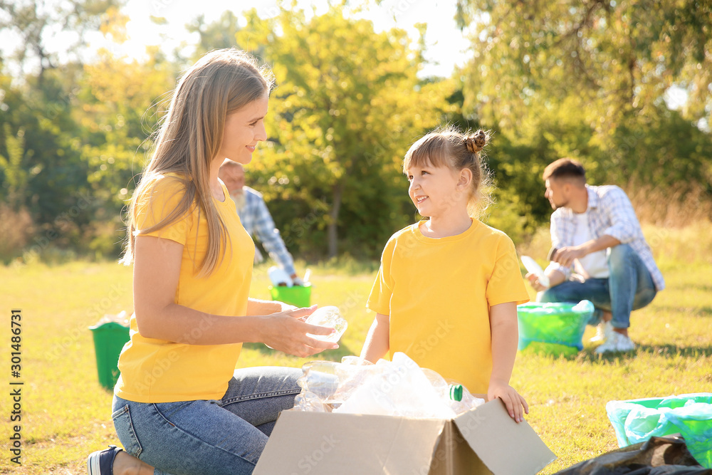 People gathering garbage outdoors. Concept of recycling