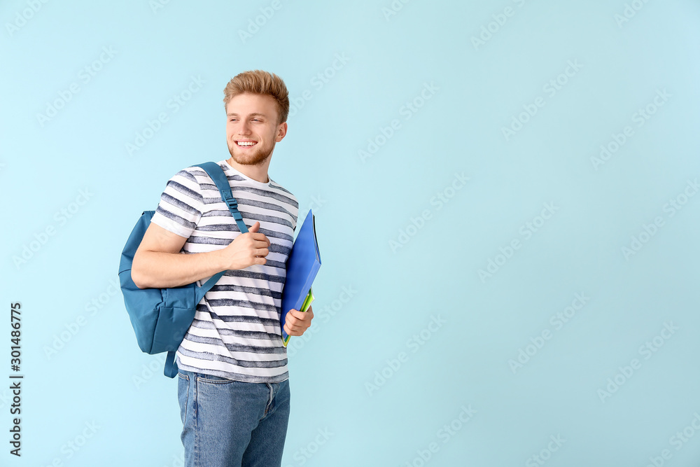 Portrait of male student on color background