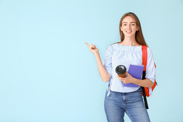 Sticker - Portrait of female student showing something on color background