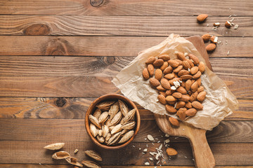 Tasty almonds on wooden background