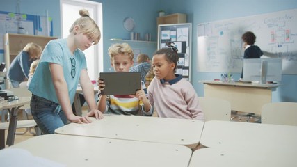 Poster - Elementary School Computer Science Class: Two Girls and Boy Use Digital Tablet Computer with Augmented Reality Software, They’re Excited, Full of Wonder, Curiosity. Children in STEM, Playing, Learning