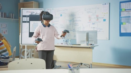 Fototapete - Elementary School Computer Science Class: Cute Girl Wearing Augmented Reality Headset and Using Controllers Learns Lessons in Virtual Reality Excited, Curious and Interested in Knowledge