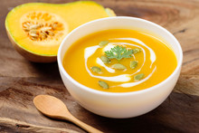 Butternut Squash Soup With Pumpkin Seed And Fresh Butternut Squash On Wooden Background