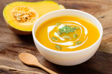 Canvas Print - Butternut squash soup with pumpkin seed and fresh butternut squash on wooden background