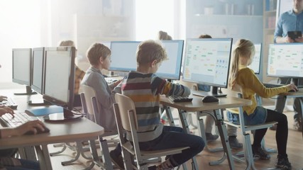Elementary School Computer Science Classroom: Smart Little Schoolchildren Work on Personal Computers, Learn Programming Language for Software Coding. Schoolchildren Getting Modern Education