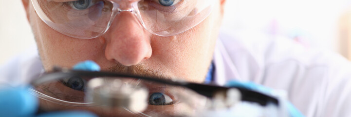 male repairman wearing blue gloves is holding a hard drive