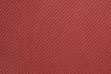Wall Mural - Knitted background of redwood color. Detailed diagonal knitting texture. Garter stitch pattern