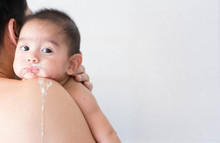 Close Up Of Asian Father Is Holding His Baby To Belching After Breast Feeding Time, Concept Of Parent Care To The Child And Over Feeding In Baby.