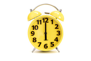 Yellow alarm clock on white at 6 o'clock