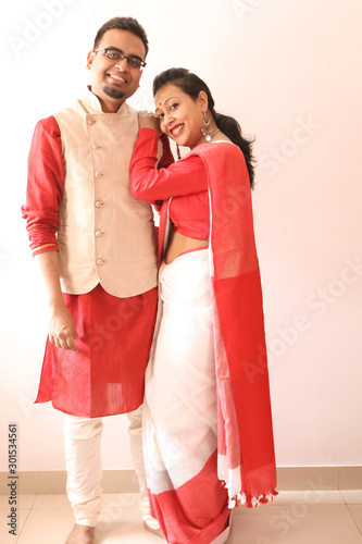 Fotomural a young indian bengali assamese married romantic couple dressed in red and white