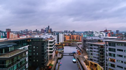 Poster - Leeds, UK. Aerial view of Leeds docks, England, UK during the sunset. Time-lapse of heavy clouds over the modern buildings, apartments in the evening and night, zoom in