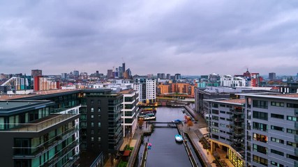 Wall Mural - Leeds, UK. Aerial view of Leeds docks, England, UK during the sunset. Time-lapse of heavy clouds over the modern buildings, apartments in the evening and night