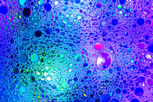 Colorful Drops Of Oil On The Water. Blue And Violet Colored Circles And Ovals. Abstract Background For Design.