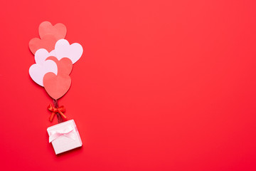valentine's day background with red and pink hearts like balloons on pink background, flat lay