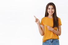 Pleasant, Friendly-looking Pretty Caucasian Woman In Yellow T-shirt Pointing Upper Left Corner, Help Customer Find Way, Recommend Product Or Event Promo, Standing White Background Confident