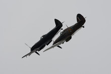 Spitfire And Hurricane World War 2 Fighters In Close Turning Formation With Light Grey Background