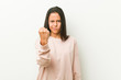 © Asier - Young cute hispanic teenager woman showing fist to camera, aggressive facial expression.