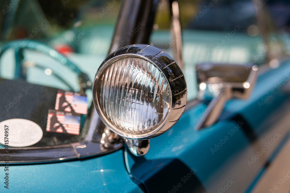 Color detail on the headlight of a vintage car sky blue color and shiny chrome, selective focus, turquoise - obrazy, fototapety, plakaty 