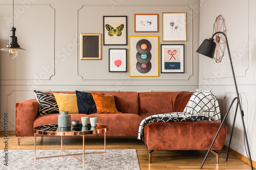 Fotografía Gallery of trendy posters in elegant grey living room interior with brown corner