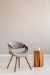 © Photographee.eu - Stylish grey wooden chair in empty living room interior with trendy wooden coffee table