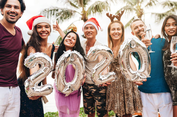 Wall Mural - Friends celebrating Christmas or New Year eve at the beach.