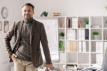 Poster - Confident mature architect in formalwear standing by desk in office