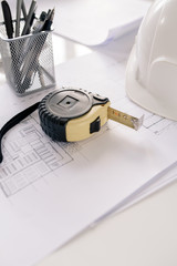 Poster - Measuring tape, bunch of pencils and sketches on workplace of modern architect