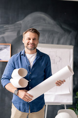 Poster - Successful mature engineer with rolled blueprints standing in front of camera