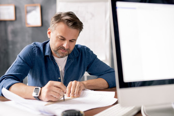 Aufkleber - Professional engineer with pencil pointing at blueprint while drawing sketch