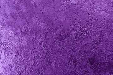 The background texture of the textured wall is purple. Stylized textural banner with space for text.