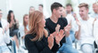 © ASDF - close up. smiling young woman applauding sitting in conference room