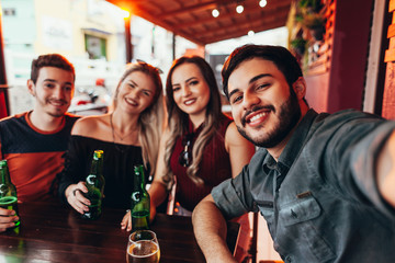 Group of friends having a good time at the bar