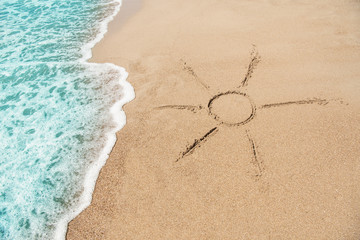 The symbol of the sun drawing on the sand.