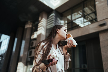 girl with greed and hunger eat a pie on a city street