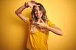 © Krakenimages.com - Young beautiful woman wearing t-shirt over yellow isolated background smiling making frame with hands and fingers with happy face. Creativity and photography concept.