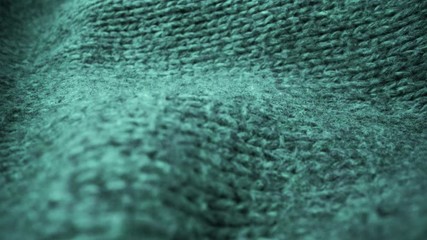 Wall Mural - Extreme detail view of sheep wool cloth texture in macro dolly shot. Flowing animal fiber material for handcraft knitting. Textile abstract background. Winter fashion clothing industry concept.