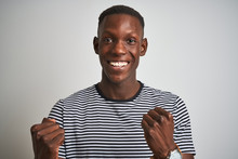 African American Man Wearing Navy Striped T-shirt Standing Over Isolated White Background Screaming Proud And Celebrating Victory And Success Very Excited, Cheering Emotion