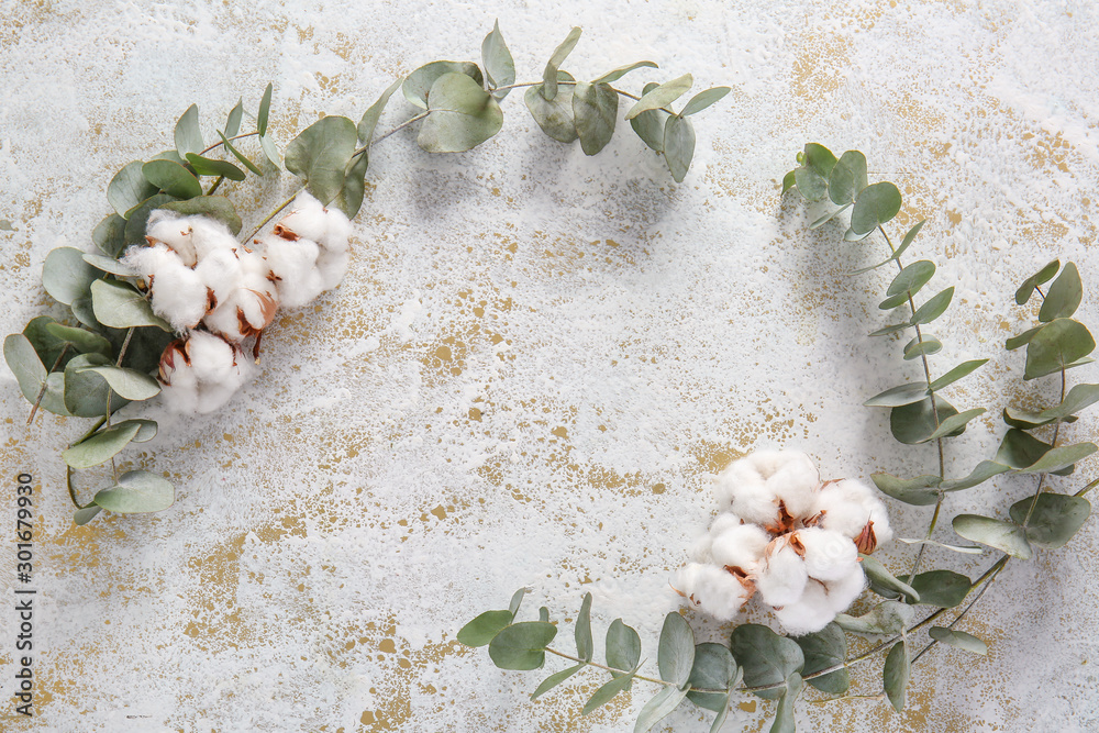 Beautiful cotton flowers and eucalyptus branches on light background