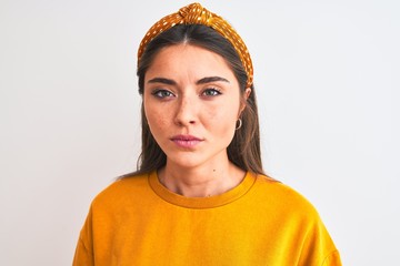 Wall Mural - Young beautiful woman wearing yellow sweater and diadem over isolated white background with a confident expression on smart face thinking serious