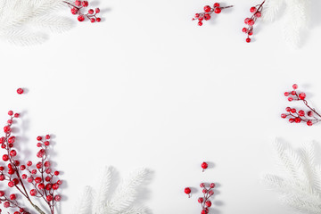 Wall Mural - christmas holiday composition. white fir tree branches and red berry on white background. christmas,