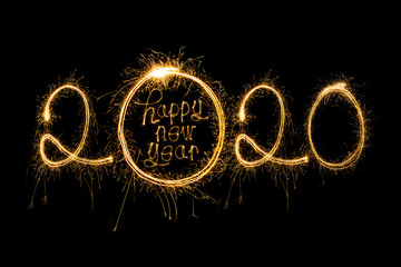 Wall Mural - Happy New Year 2020. Creative text Happy New Year 2020 written sparkling sparklers isolated on black background for design