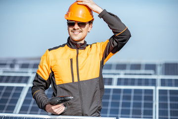 Wall Mural - well-equipped workman on a solar station