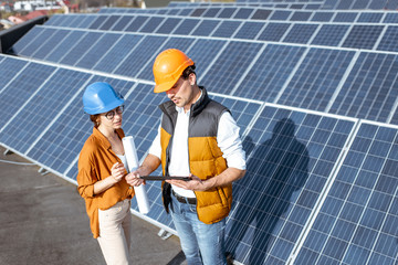 Wall Mural - engineers on a solar power station